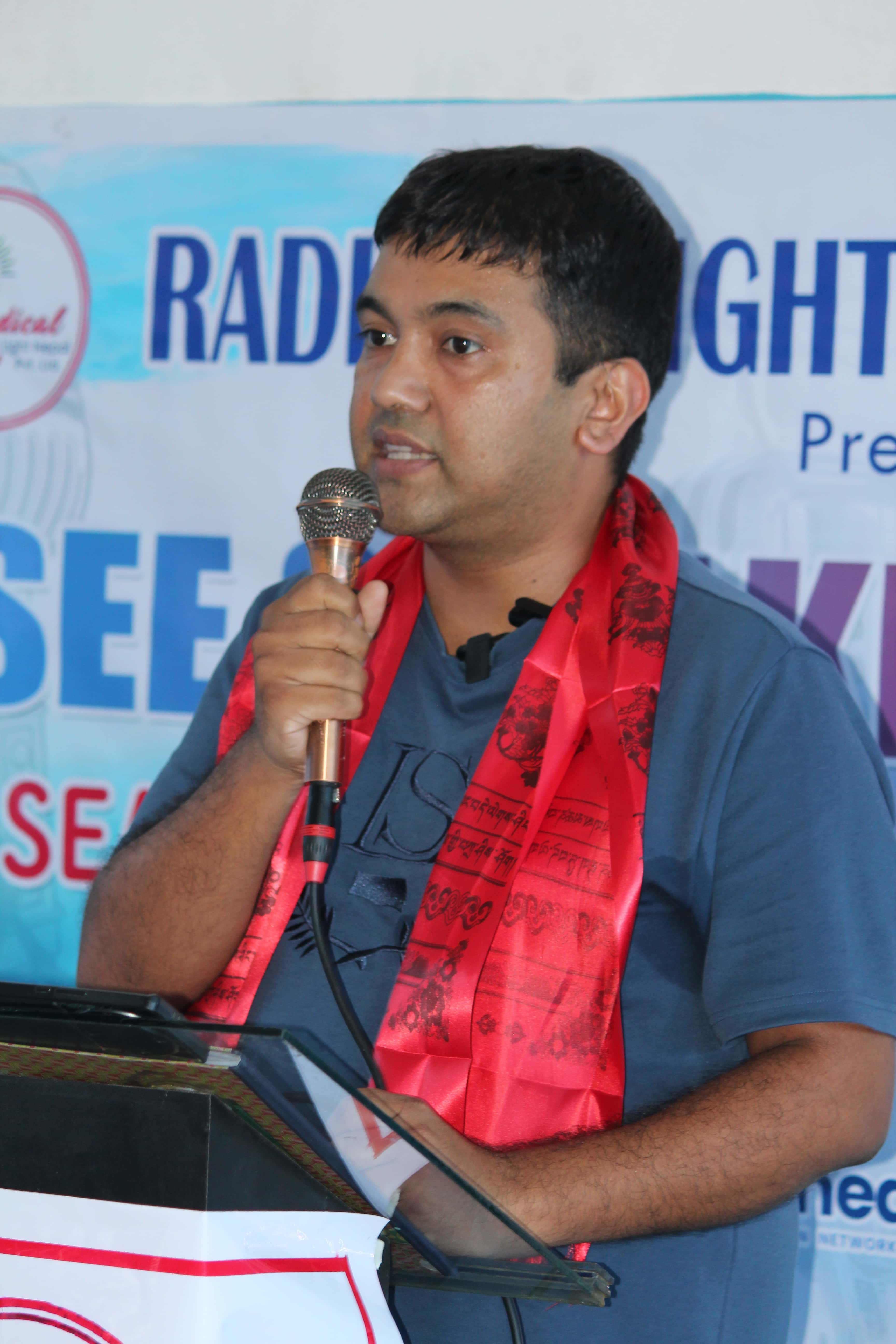 Surendra Ghimire speaking at an education conference